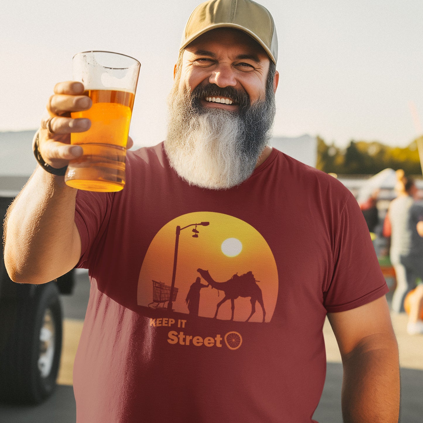 Man holding a glass of beer and wearing a burgundy t-shirt with a graphic design outdoors. This street art t shirt stencil represents inner city street life as a culture of it's own. There is a ground level reality mixed with trustworthy honestly at street level in towns and cities across the planet. Wherever you are in the world, may the street be with you. Made from 100% organic ring-spun cotton, this urban art t shirt is unisex, high-quality, super comfy, and best of all, eco-friendly.
