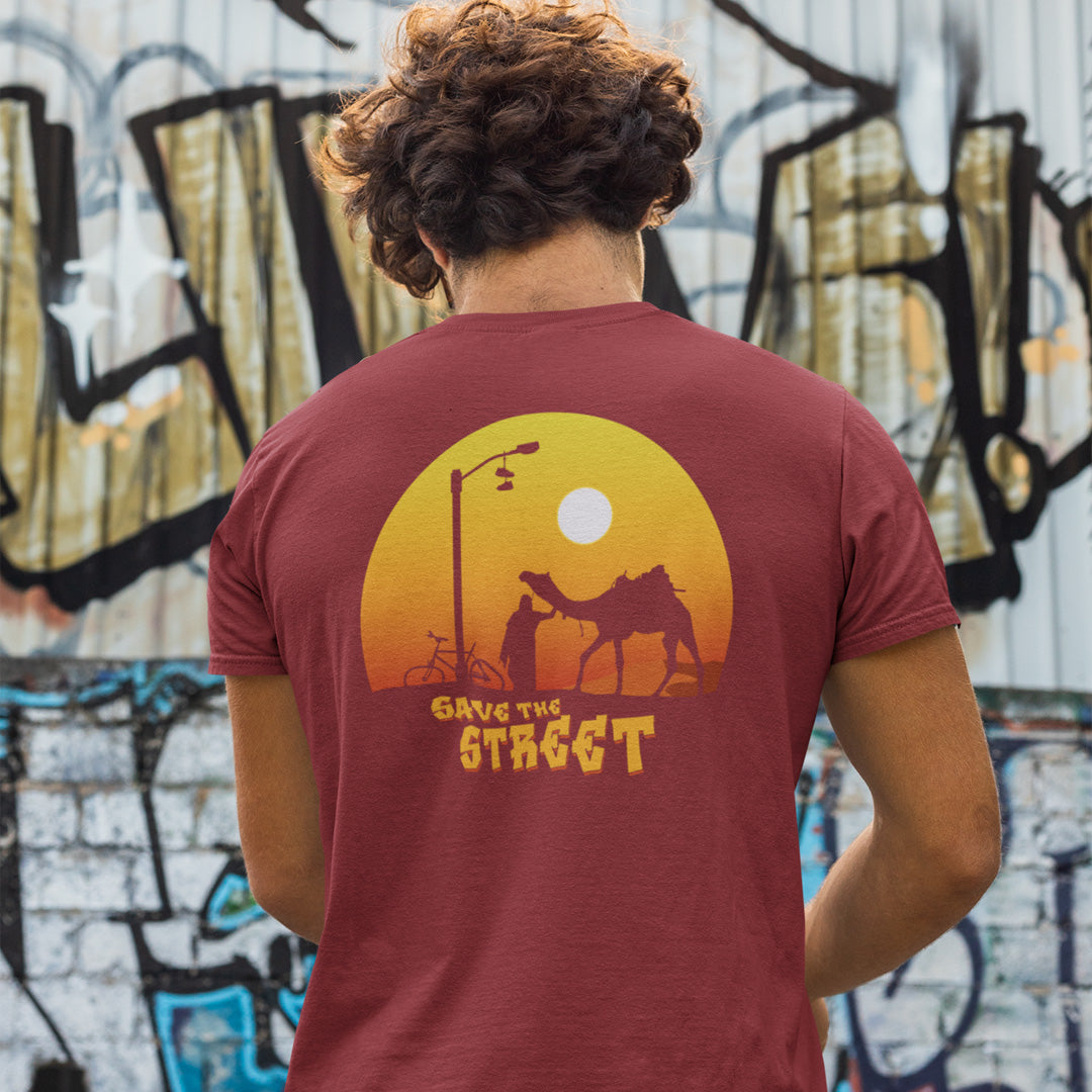 Person wearing a burgundy t-shirt , standing in front of a graffiti-covered wall.This street art t shirt stencil represents inner city street life as a culture of it's own. There is a ground level reality mixed with trustworthy honestly at street level in towns and cities across the planet. Wherever you are in the world, may the street be with you. Made from 100% organic ring-spun cotton, this urban art t shirt is unisex, high-quality, super comfy, and best of all, eco-friendly.