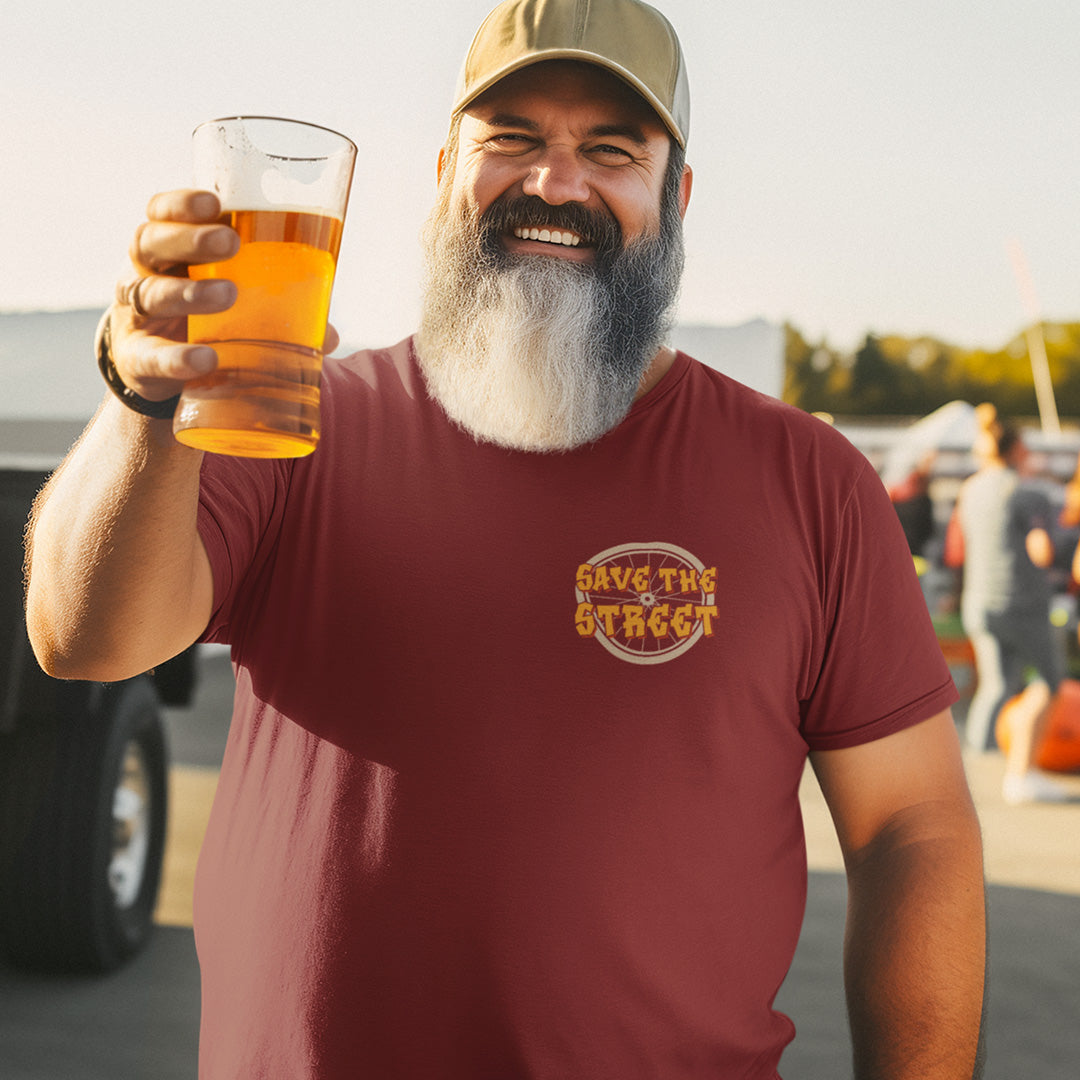 Man with a beard holding a glass of beer, wearing a 'Save the Street' t-shirt. This street art t shirt stencil represents inner city street life as a culture of it's own. There is a ground level reality mixed with trustworthy honestly at street level in towns and cities across the planet. Wherever you are in the world, may the street be with you. Made from 100% organic ring-spun cotton, this urban art t shirt is unisex, high-quality, super comfy, and best of all, eco-friendly.