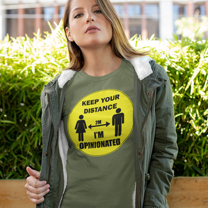 Woman wearing a khaki shirt with a yellow graphic and text, standing outdoors. This opinionated t shirt design is a warning to people who speak before they think. It's best to warn them before they try to treat you like a clone. Made from 100% organic ring-spun cotton, this urban art t shirt is unisex, high-quality, super comfy, and best of all, eco-friendly.