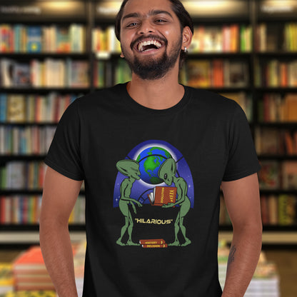 Person wearing a black t-shirt with an alien design in a bookstore. This funny alien t shirt suggest we are being lied to about our history and the aliens know the truth. A design for alien loving conspiracy theorists. Have the aliens had more influence in our lives than we are lead to believe ? Made from 100% organic ring-spun cotton, these cool sci fi t shirts are unisex, high-quality, super comfy, and best of all, eco-friendly.
