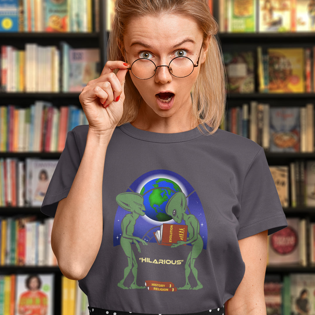 Person wearing a t-shirt with an alien holding books design in front of a bookshelf. This funny alien t shirt suggest we are being lied to about our history and the aliens know the truth. A design for alien loving conspiracy theorists. Have the aliens had more influence in our lives than we are lead to believe ? Made from 100% organic ring-spun cotton, these cool sci fi t shirts are unisex, high-quality, super comfy, and best of all, eco-friendly.