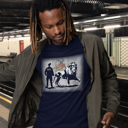 A man with dreadlocks standing in a tube station, wearing a French navy blue  crew neck t-shirt with a graffiti stencil design of a security guard checking the underside of the Lion of Judah for explosives.