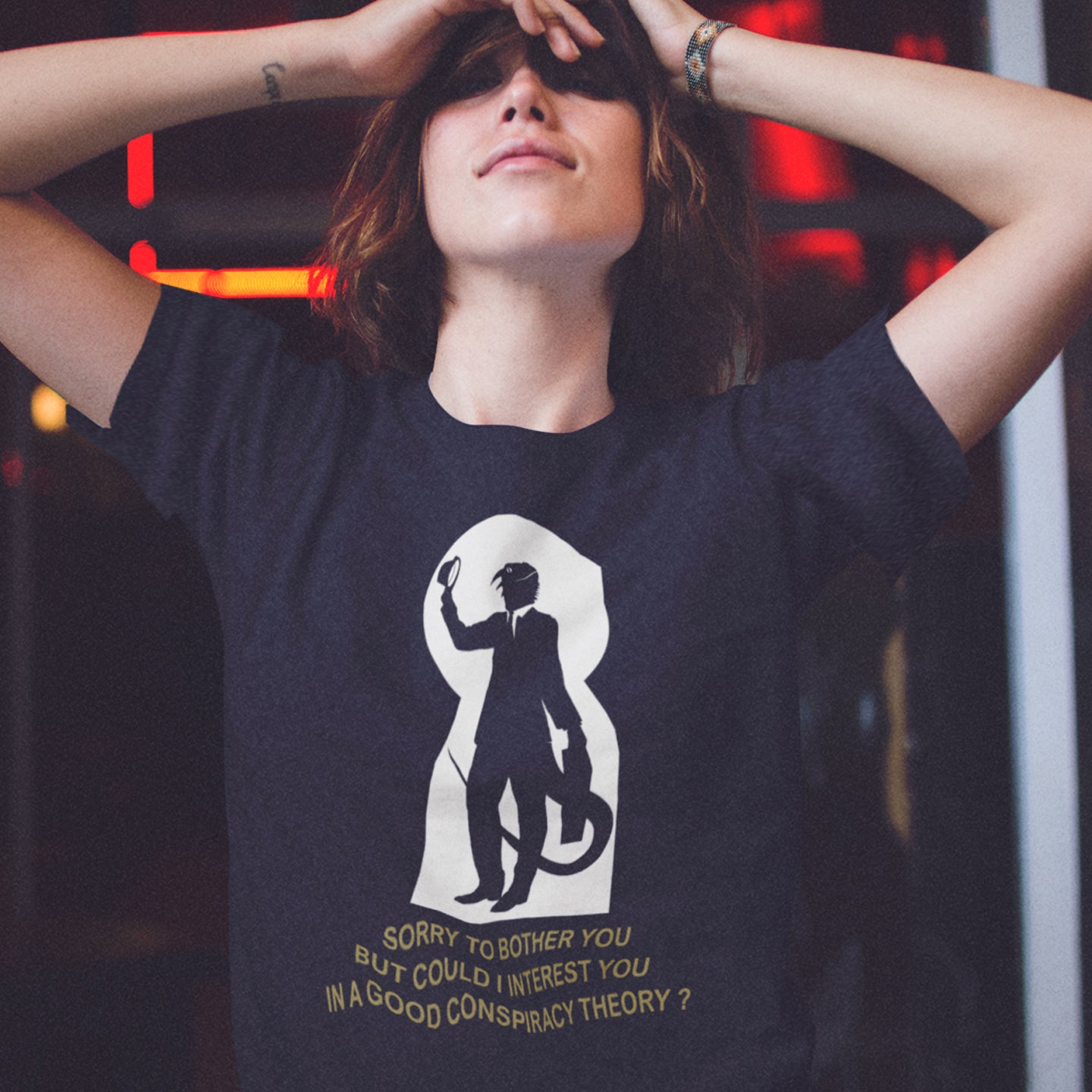 Person wearing a French navy t-shirt with a graphic design and text. A funny conspiracy theory t-shirt. Just an ordinary, everyday, door-to-door conspiracy theory salesman. Made from 100% organic ring-spun cotton, this reptilian alien t-shirt is unisex, high-quality, super comfy, and best of all, eco-friendly.