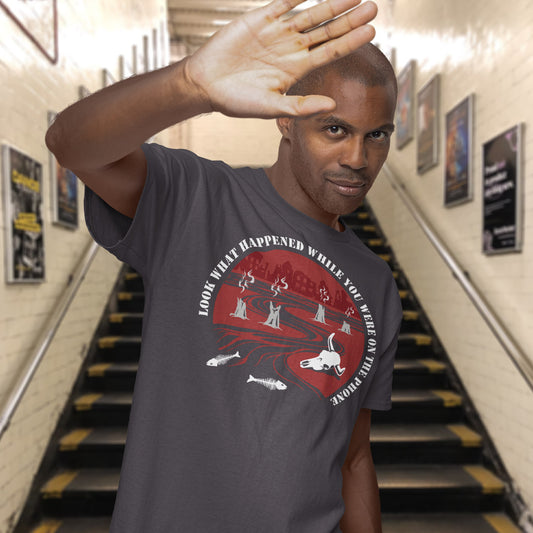 Man wearing a t-shirt with a graphic design in an indoor setting. An anti mobile phone abuse theme mixed with a save the earth t shirt. This design is a harsh view of what's happening to the planet while people are distracted by their phones. Made from 100% organic ring-spun cotton, this save the planet t shirt is unisex, high quality, super comfy, and best of all, eco-friendly.