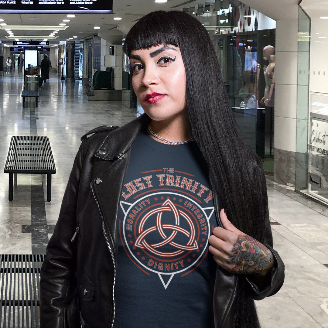 Woman wearing a black leather jacket and a graphic t-shirt in a mall setting. A broken society t shirt reflecting a sign of the times. This unique design represents the erosion of morality in modern society and the loss of ethical thinking. As people are dehumanised and money is worshipped, is integrity a thing of the past ? Show your defiance with this original 'Lost Trinity design. Made from 100% organic ring-spun cotton, this counter culture t shirt is unisex, high quality, super comfy, and best of all, 