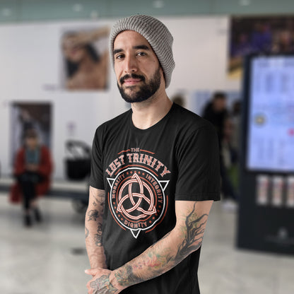 Man standing in shopping centre wearing a 'lost trinity' t shirt. A broken society t shirt reflecting a sign of the times. This unique design represents the erosion of morality in modern society and the loss of ethical thinking. As people are dehumanised and money is worshipped, is integrity a thing of the past ? Show your defiance with this original 'Lost Trinity design. Made from 100% organic ring-spun cotton, this counter culture t shirt is unisex, high quality, super comfy, and best of all, eco-friendly