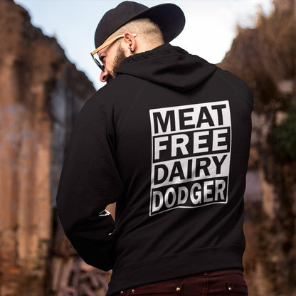 Person wearing a black hoodie with 'MEAT FREE DAIRY DODGER' text on the back, standing outdoors. This vegan hoodie promotes a witty alternative to the 'non-dairy' label. Never mind 'plant based' as a new label for vegan . This is straight off the streets of East London. Comfortable and practical. It's extra soft and has a convenient front pouch pocket. Made from organic cotton and recycled polyester, this vegan hoodie is a great eco-friendly choice.