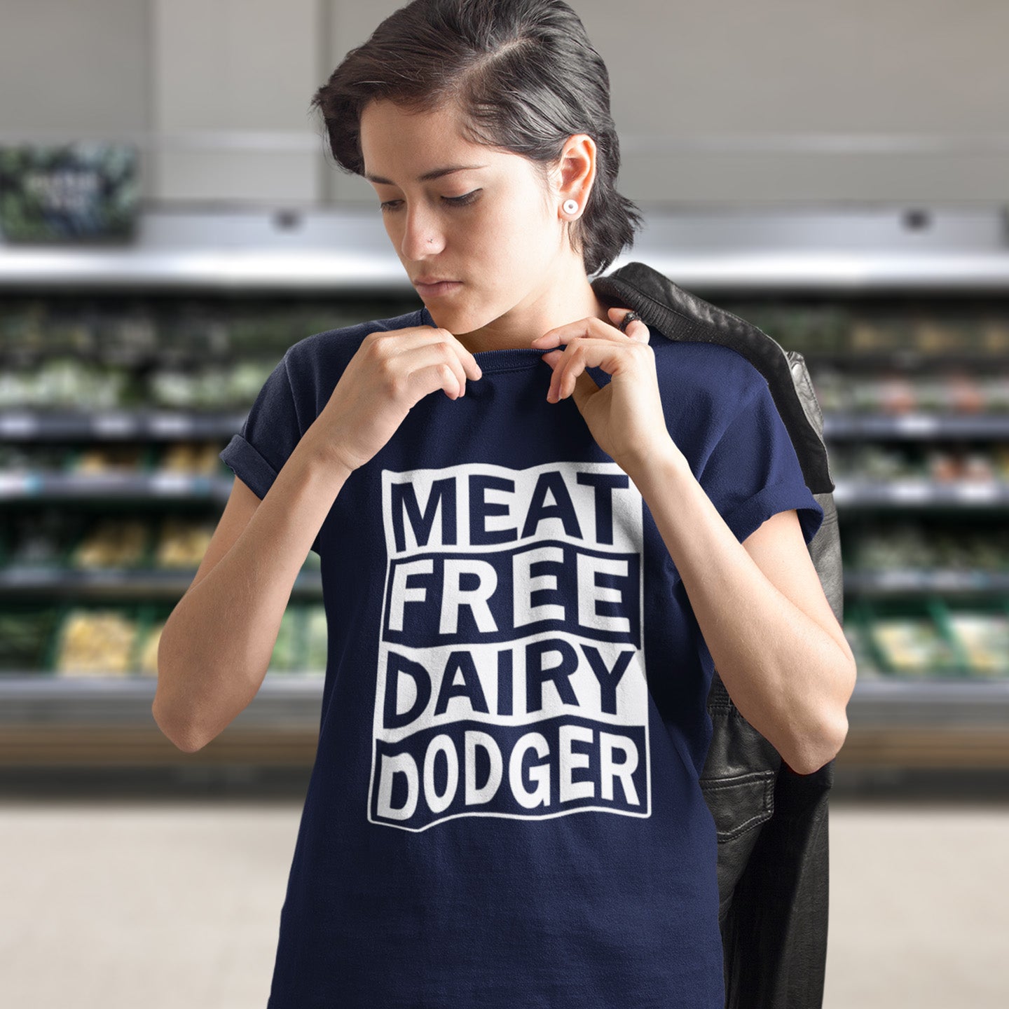 Person wearing a 'MEAT FREE DAIRY DODGER' t-shirt in a grocery store. A vegan meat free t shirt promoting a witty alternative to the 'vegan' label. Never mind 'plant based' as a new label for vegan . This is straight off the streets of East London. Made from 100% organic ring-spun cotton, this vegan dairy free t shirt is unisex, high-quality, super comfy, and best of all, eco-friendly.
