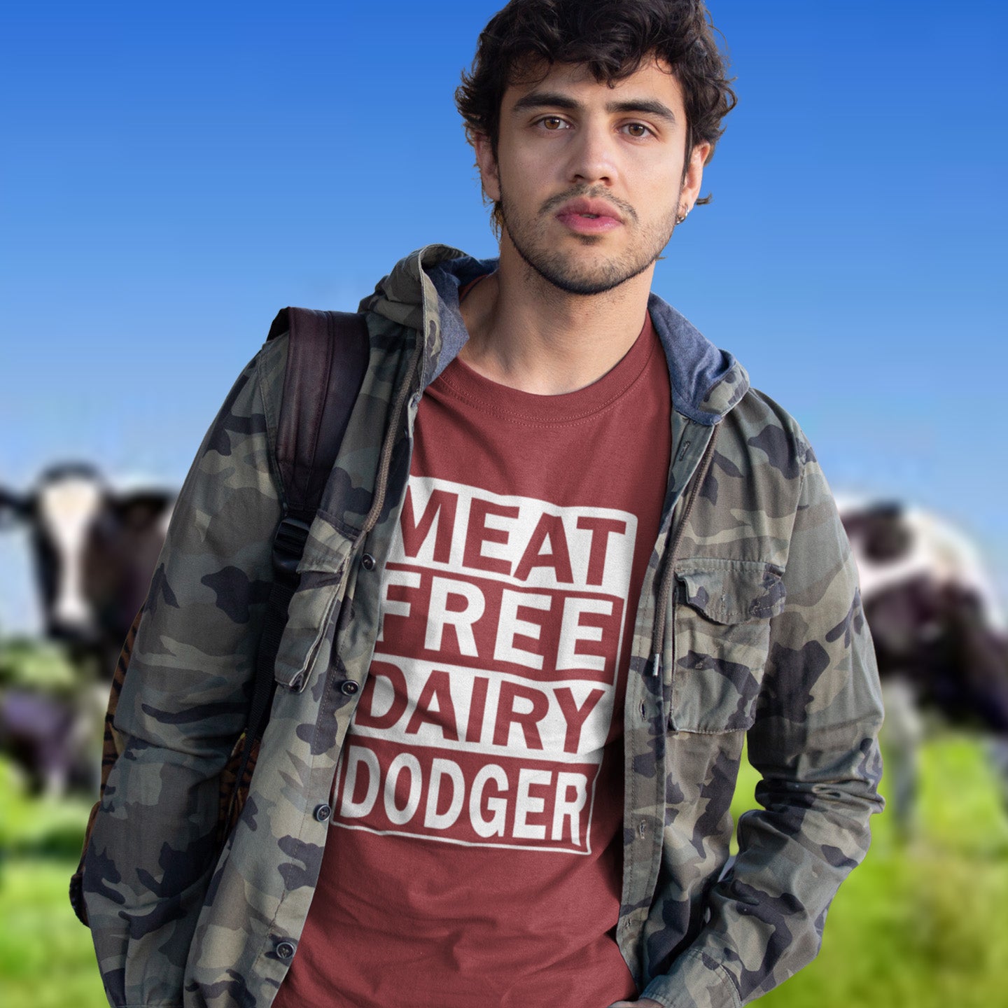 Man wearing a burgundy 'meat free dairy dodger' t-shirt outdoors. A vegan meat free t shirt promoting a witty alternative to the 'vegan' label. Never mind 'plant based' as a new label for vegan . This is straight off the streets of East London. Made from 100% organic ring-spun cotton, this vegan dairy free t shirt is unisex, high-quality, super comfy, and best of all, eco-friendly.