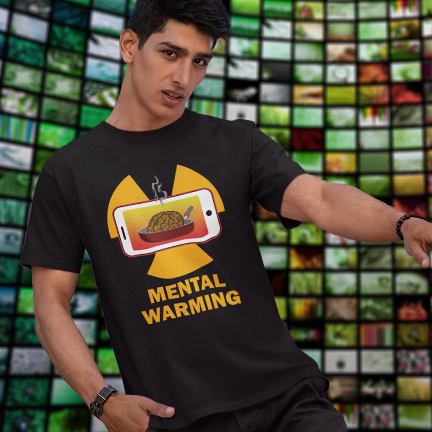 Person wearing a black t-shirt with a graphic design and text 'Mental Warning' in front of a colourful mosaic background. A save the environment t shirt looking at the affects of microwaves on the brain. If you are worried about global warming, look at what are we doing to our minds. This anti smart phone design reminds people that environmental issues are not our only concern. Made from 100% organic ring-spun cotton, this social awareness t-shirt is unisex, high-quality, super comfy, and best of all, eco-f