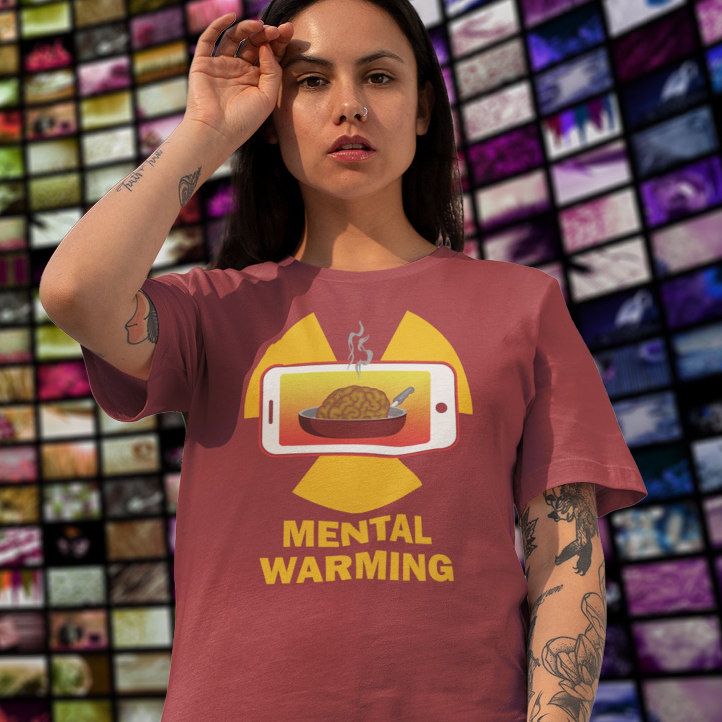Person wearing a t-shirt with a graphic design and text 'Mental Warming' in front of a colourful background. A save the environment t shirt looking at the affects of microwaves on the brain. If you are worried about global warming, look at what are we doing to our minds. This anti smart phone design reminds people that environmental issues are not our only concern. Made from 100% organic ring-spun cotton, this social awareness t-shirt is unisex, high-quality, super comfy, and best of all, eco-friendly.