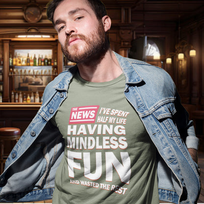 Man wearing a khaki t-shirt with humorous text in a bar setting. A witty quotes t shirt with a front page life philosophy. When you look back over your life, How are you going to see it ? Made from 100% organic ring-spun cotton, these clever slogan t shirts are unisex, high-quality, super comfy, and best of all, eco-friendly.