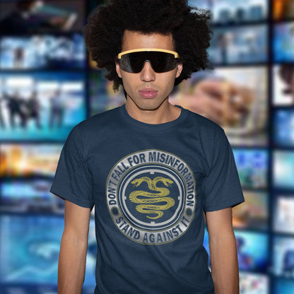 Person wearing a French navy blue t-shirt with a snake graphic and text in front of a blurred background with screens. A non conformist t shirt design. Call it SPIN, LIES or GASLIGHTING , It's all misinformation. There's a lot of it about these days and most of it seems to be coming from above. Made from 100% organic ring-spun cotton, this social awareness t-shirt is unisex, high-quality, super comfy, and best of all, eco-friendly.