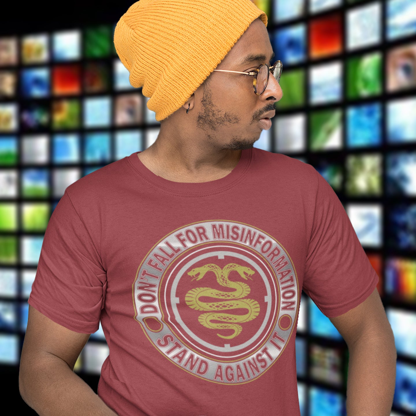 Person wearing a burgundy t-shirt with a snake design and text, standing in front of a colourful grid background. A unique political t-shirt design. Call it SPIN, LIES or GASLIGHTING , It's all misinformation. There's a lot of it about these days and most of it seems to be coming from above. Made from 100% organic ring-spun cotton, this social awareness t-shirt is unisex, high-quality, super comfy, and best of all, eco-friendly.