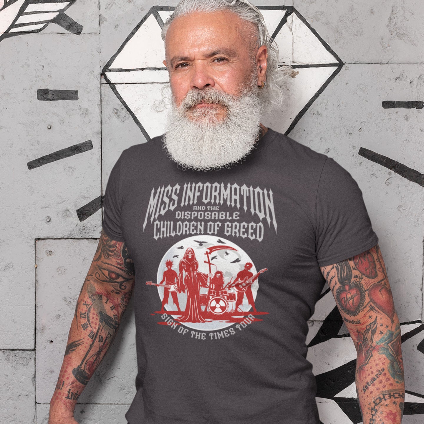Older man standing against a graffiti wall wearing a 'Miss information; t shirt. A broken society t shirt in the form of a Spoof Goth-rock band design with a dig at modern culture. If you feel you are surrounded by misinformation and mercenaries, show you're no fool to the state of society by mocking it with this satirical tour t shirt. Made from 100% organic ring-spun cotton, this counter culture t shirt is unisex, high quality, super comfy, and best of all, eco-friendly.