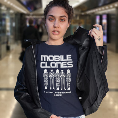 Person wearing a black jacket and a t-shirt with 'MOBILE CLONES' design in a mall setting. Smart phones are taking the imagination out of life. Soon we will all look the same, think the same, and all buy the same un-needed online products, or has that already happened ? Made from 100% organic ring-spun cotton, this anti-consumerism t-shirt is unisex, high-quality, super comfy, and best of all, eco-friendly.