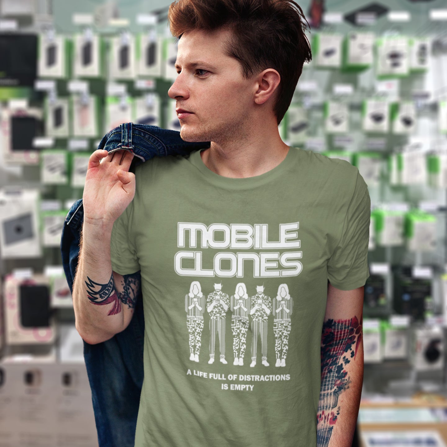 Person wearing a khaki t-shirt with 'Mobile Clones' design in front of a store display. Smart phones are taking the imagination out of life. Soon we will all look the same, think the same, and all buy the same un-needed online products, or has that already happened ? Made from 100% organic ring-spun cotton, this anti-consumerism t-shirt is unisex, high-quality, super comfy, and best of all, eco-friendly.