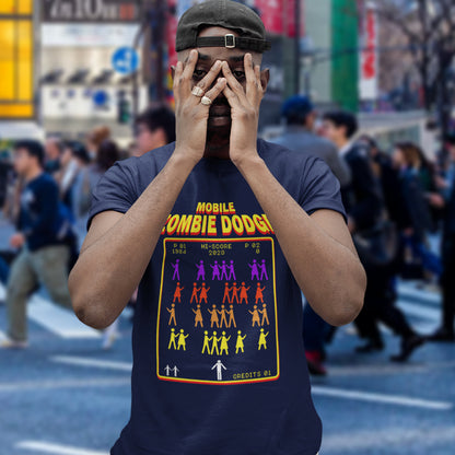 Person wearing a t-shirt with a graphic design in an urban setting. A funny gamer t shirt design for anyone who feels they are in a repetitive 80's video game every time they enter a crowded street scene. Welcome to the age of the mobile phone and lack of social awareness. Made from 100% organic ring-spun cotton, this unisex gamer t shirt is alternative and original. It's high-quality, super comfy, and best of all, eco-friendly.