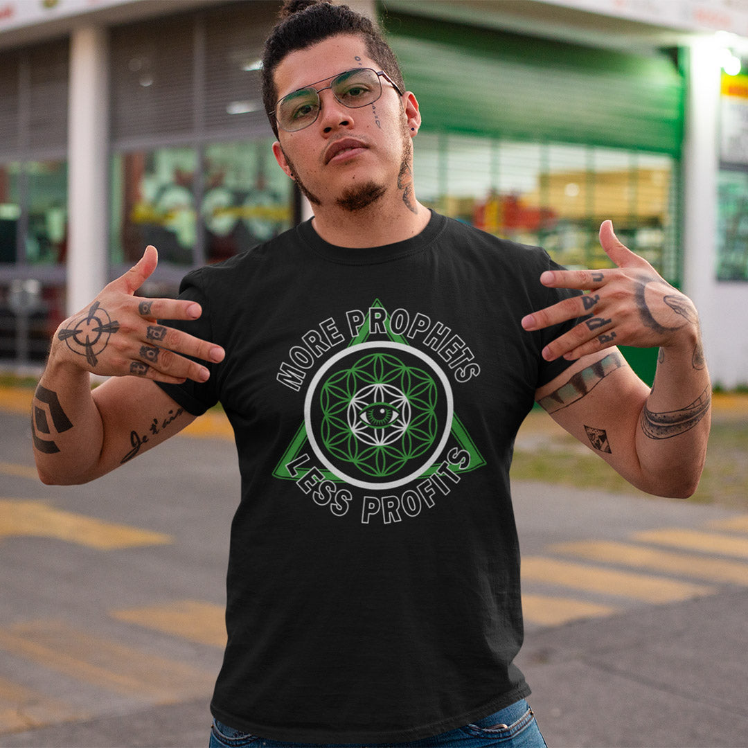 Man wearing a black t-shirt with a green and white graphic design outdoors. This anti capitalism t shirt suggests we are following the wrong kind of profit. Society will never advance as a whole through greed but could really benefit from some ethical guidance. Made from 100% organic ring-spun cotton, this anti capitalist t shirt is unisex, high quality, super comfy, and best of all, eco-friendly.
