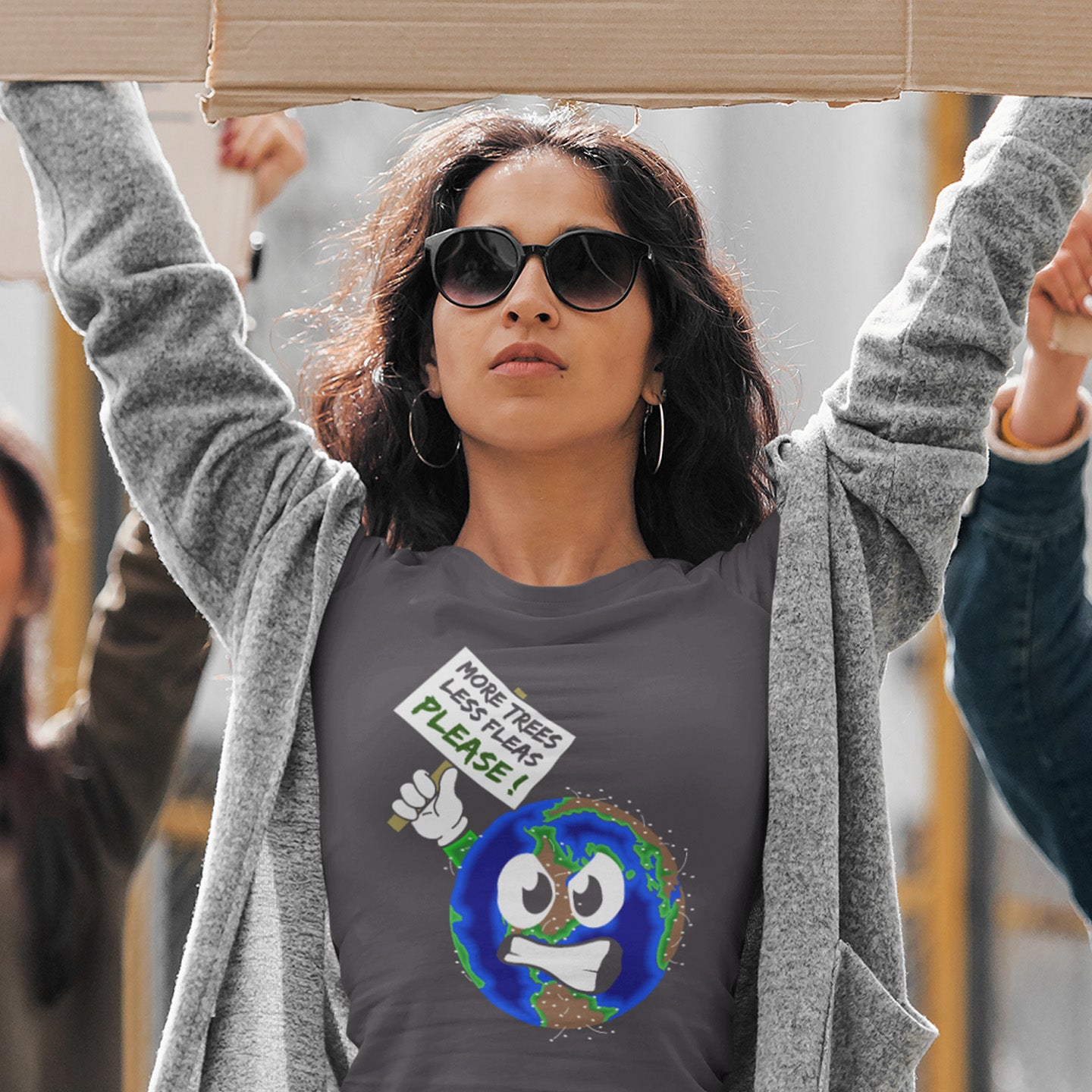 Woman wearing a t-shirt with an environmental message, holding a cardboard sign. A save the planet t-shirt design satirically suggesting how the planet may feel about over-population and deforestation. A unique design for any climate concern demonstration, protest march or every day attitude. Made from 100% organic ring-spun cotton, this environmental t-shirt is unisex, high-quality, super comfy, and best of all, eco-friendly.