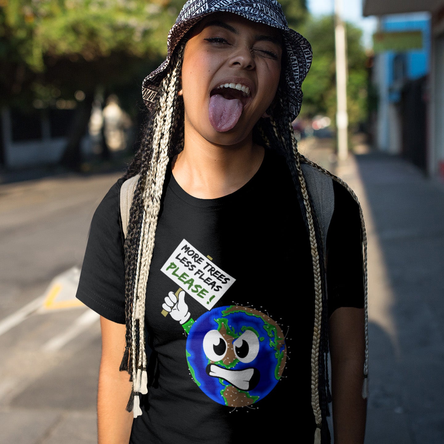 Person wearing a black t-shirt with an environmental message on a street. A save the planet t-shirt design satirically suggesting how the planet may feel about over-population and deforestation. A unique design for any climate concern demonstration, protest march or every day attitude. Made from 100% organic ring-spun cotton, this environmental t-shirt is unisex, high-quality, super comfy, and best of all, eco-friendly.