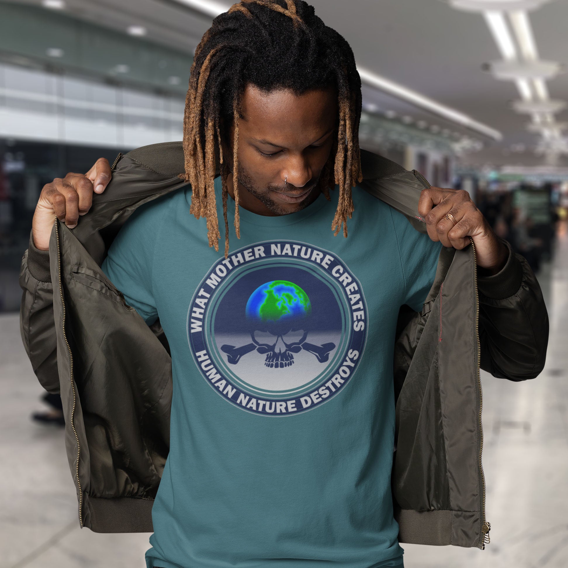 Person wearing a stargazer t-shirt with a graphic design and text, standing in an indoor setting. A save the world t shirt. Mother nature vs. human nature. Environmental concern at it's rawest. A design for all eco warriors who would love to save the planet. Made from 100% organic ring-spun cotton, this save the planet t shirt design is unisex, high-quality, super comfy, and best of all, eco-friendly.