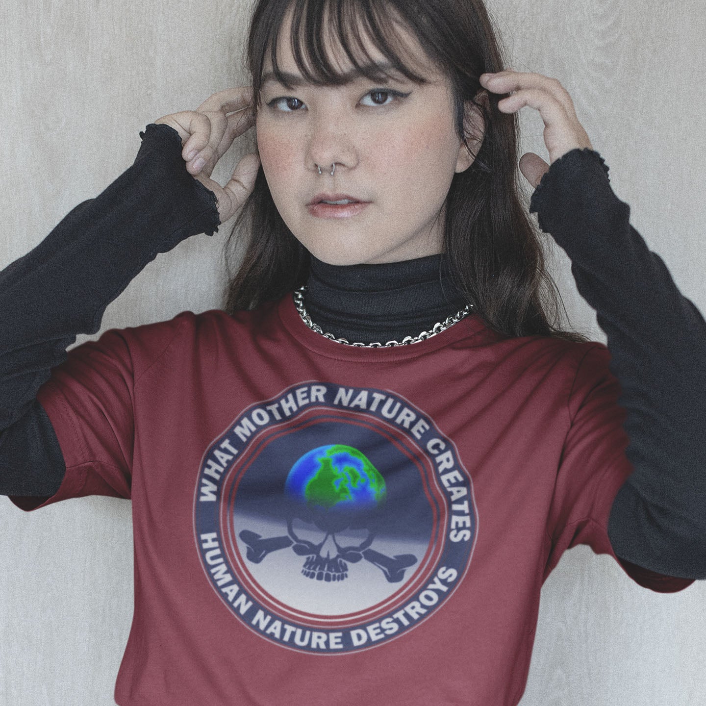 Person wearing a red t-shirt with a graphic design and text. Mother nature vs. human nature. Climate concern at it's rawest. A design for all eco warriors who would love to save the planet. Made from 100% organic ring-spun cotton, this environmental awareness t-shirt is unisex, high-quality, super comfy, and best of all, eco-friendly.