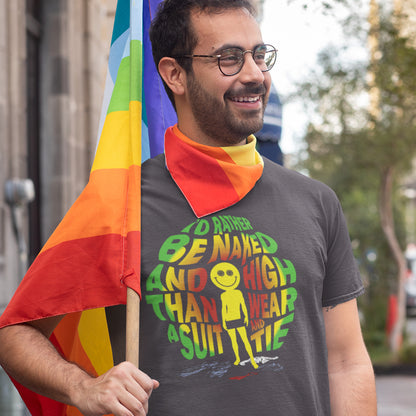 A man wearing glasses and a dark gray graphic t-shirt with a rainbow bandana around his neck, holding a rainbow pride flag outdoors.
