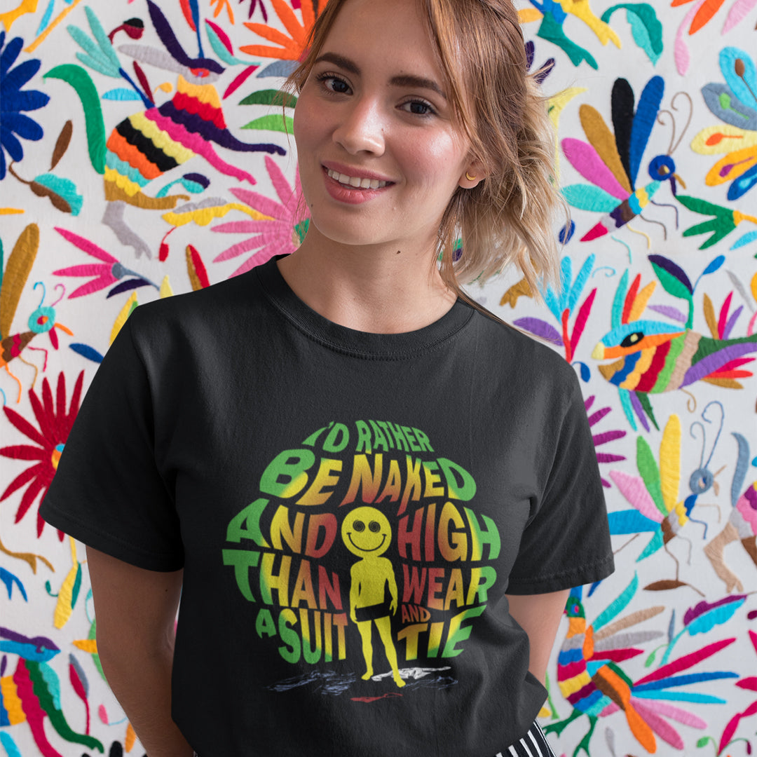 A woman wearing a black graphic t-shirt with a colorful text print, standing in front of a vibrant, multicolored patterned background.