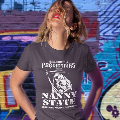 A woman wearing a dark gray graphic t-shirt with a white print of the Grim Reaper and the text 'BRIM FUTURE PREDICTIONS NANNY STATE SCREENING AROUND THE WORLD' in front of a colorful graffiti wall.