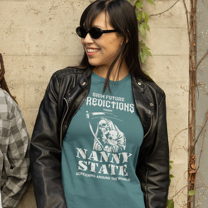 A woman wearing a teal graphic t-shirt with a white 'Nanny State' print, layered under a black leather jacket, standing against a textured beige wall.