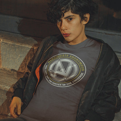 Person wearing a t-shirt with a logo and text, sitting against a stone wall. A satirical t-shirt design suggesting narcissism is an illness in need of treatment. Wouldn't it be good if there was a place narcissists could go to get therapy and support for their disease. Made from 100% organic ring-spun cotton, this emotional intelligence t-shirt is unisex, high-quality, super comfy, and best of all, eco-friendly.