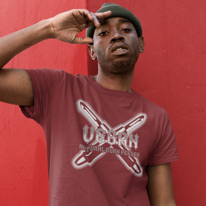 Person wearing a burgundy t-shirt with 'Vegan' graphic design against a red background. A funny vegan t-shirt with menace. A tribute to the number one weapon of choice for a planet lover. A unique dairy free design for all plant based warriors. Made from 100% organic ring-spun cotton, this vegan t-shirt is unisex, high-quality, super comfy, and best of all, eco-friendly.