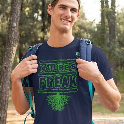 Man wearing a French navy blue t-shirt with 'Nature's Freak' design outdoors. A protect the planet t shirt design for all children of nature who are proud to be part of a beautiful eco system. This stencil graffiti t shirt is ideal if you believe you are surrounded by freaks of nature while feeling like one of nature's freaks. Made from 100% organic ring-spun cotton, this nature lover t shirt is unisex, high-quality, super comfy, and best of all, eco-friendly.
