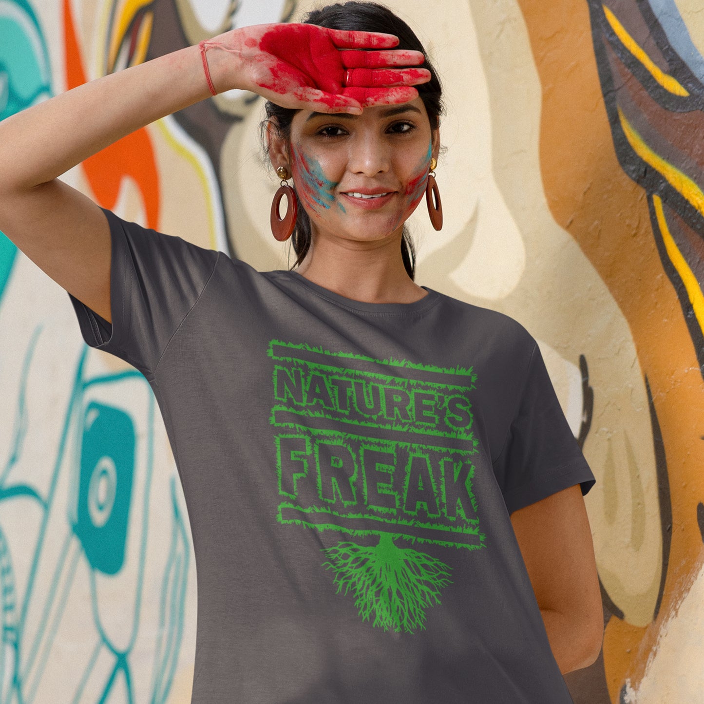 Person wearing a t-shirt with 'Nature's Freak' design in front of a colourful mural. A protect the planet t shirt design for all children of nature who are proud to be part of a beautiful eco system. This stencil graffiti t shirt is ideal if you believe you are surrounded by freaks of nature while feeling like one of nature's freaks. Made from 100% organic ring-spun cotton, this nature lover t shirt is unisex, high-quality, super comfy, and best of all, eco-friendly.
