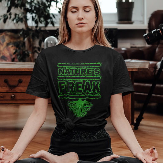 Woman meditating wearing a black t-shirt with 'Nature's Freak' design. A protect the planet t shirt design for all children of nature who are proud to be part of a beautiful eco system. This stencil graffiti t shirt is ideal if you believe you are surrounded by freaks of nature while feeling like one of nature's freaks. Made from 100% organic ring-spun cotton, this nature lover t shirt is unisex, high-quality, super comfy, and best of all, eco-friendly.