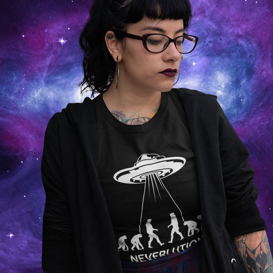 Person wearing a black t-shirt with a UFO design against a cosmic background. An alien conspiracy theory t-shirt suggesting a different path of our evolution. Did evolution never really happen the way we are told, or is there a more intergalactic and colourful answer ? Made from 100% organic ring-spun cotton, this conspiracy theory t-shirt is unisex, high-quality, super comfy, and best of all, eco-friendly.