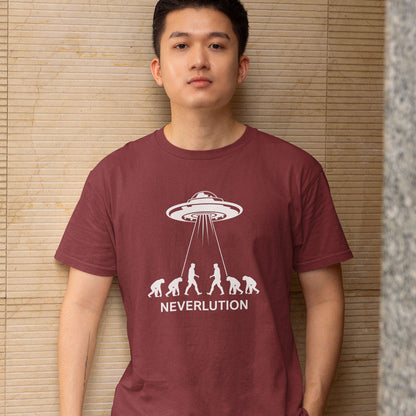 A man wearing a maroon short-sleeve t-shirt with a white graphic of an alien spaceship and the word 'NEVERLUTION' printed on the front, standing against a beige bamboo screen background.
