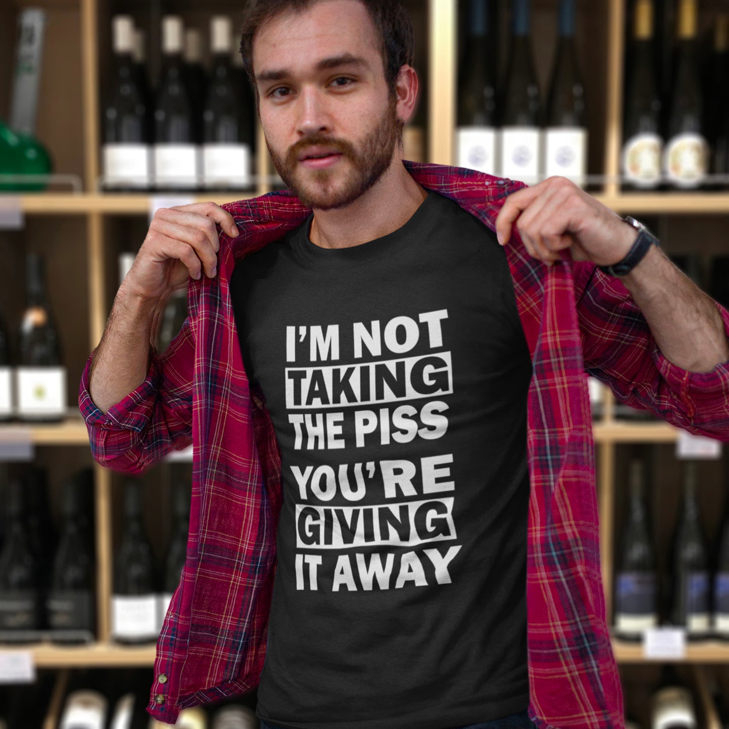 Man wearing a black t-shirt with humorous text in a wine store. A clever slogan t shirt design suggesting some people just set themselves up to be laughed at. Light hearted banter between friends , "No offence intended mate". Made from 100% organic ring-spun cotton, this sarcastic slogan t shirt is unisex, high-quality, super comfy, and best of all, eco-friendly.