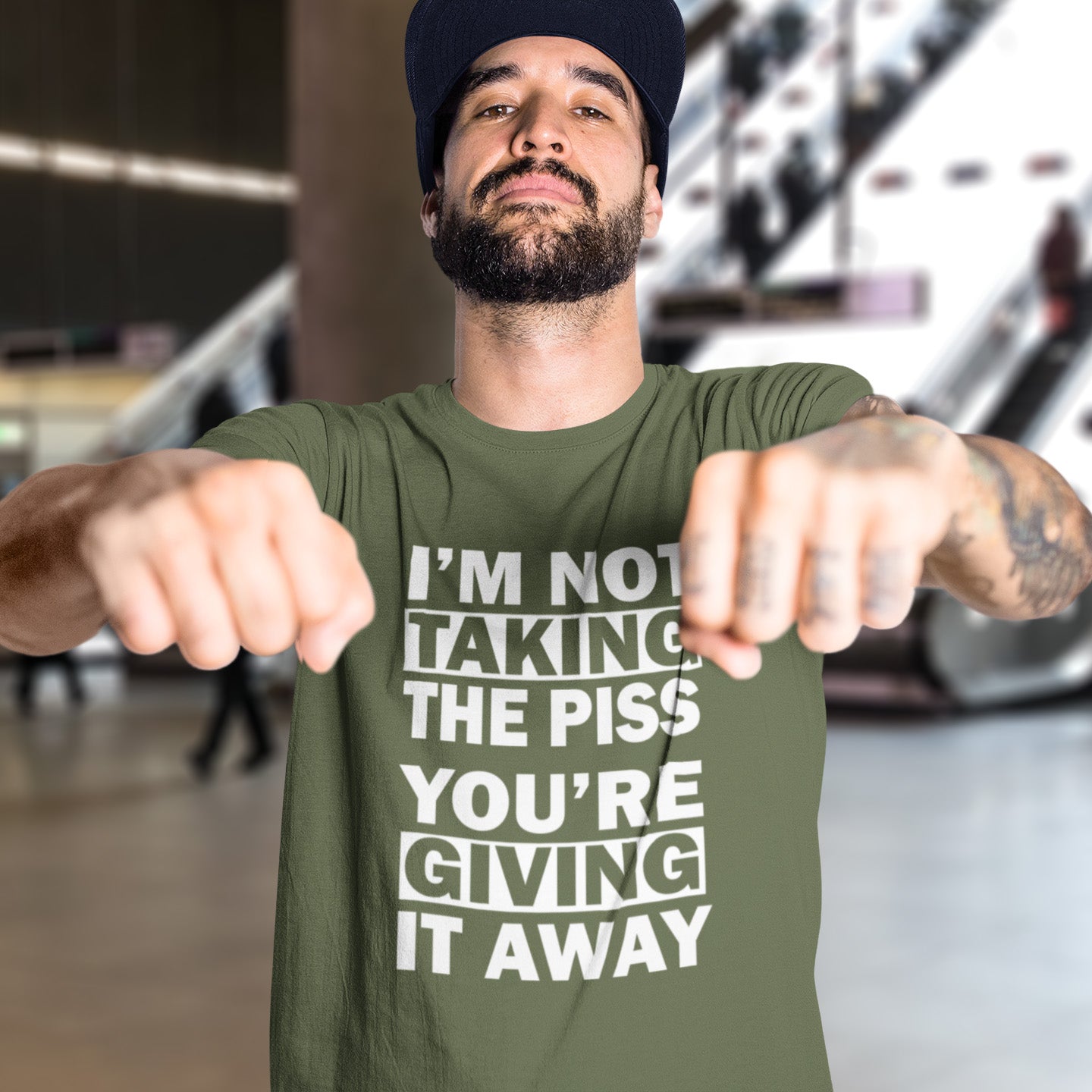 Man wearing a khaki t-shirt with text in an indoor setting. A clever slogan t shirt design suggesting some people just set themselves up to be laughed at. Light hearted banter between friends , "No offence intended mate". Made from 100% organic ring-spun cotton, this sarcastic slogan t shirt is unisex, high-quality, super comfy, and best of all, eco-friendly.