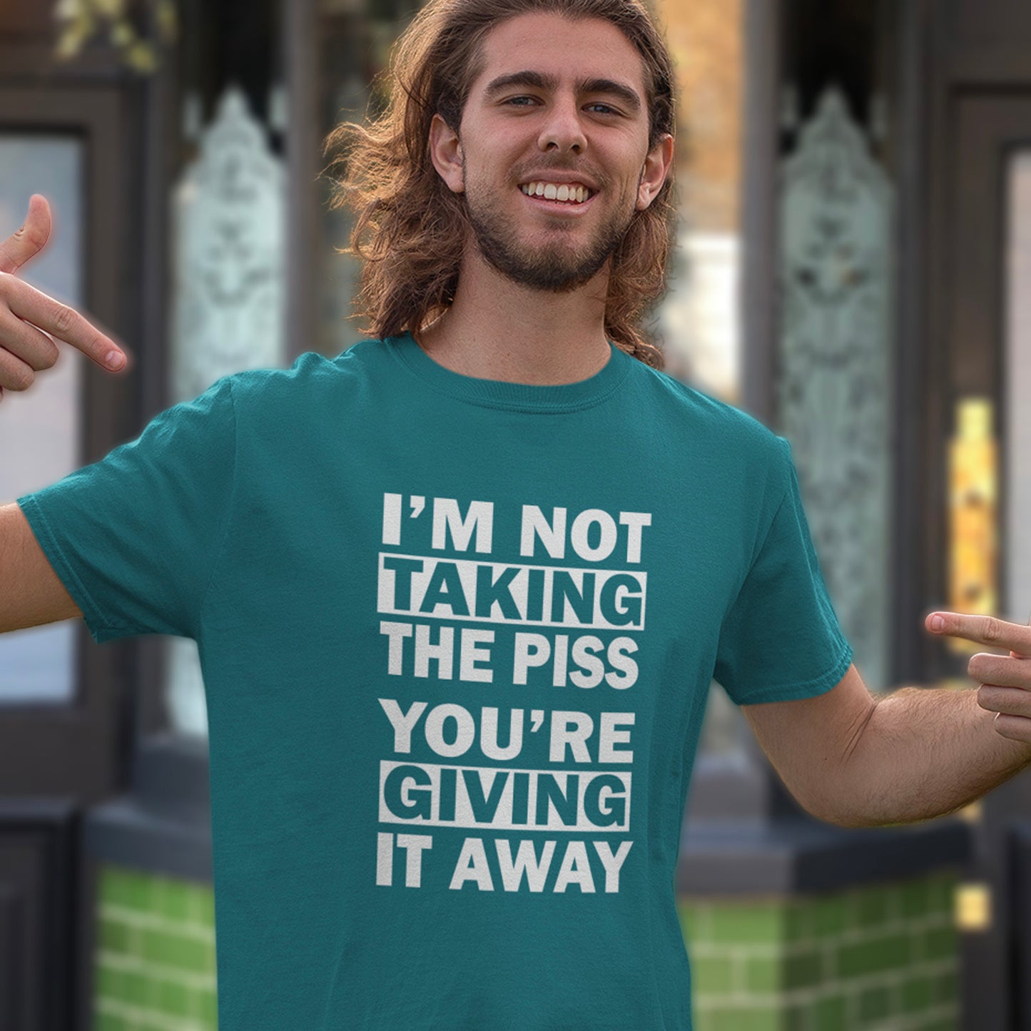 Man wearing a stargazer t-shirt with humorous text in an outdoor setting. A clever slogan t shirt design suggesting some people just set themselves up to be laughed at. Light hearted banter between friends , "No offence intended mate". Made from 100% organic ring-spun cotton, this sarcastic slogan t shirt is unisex, high-quality, super comfy, and best of all, eco-friendly.