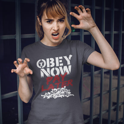 Person wearing a t-shirt with 'Obey Now Pay Later' text in front of a grid background. This broken society t shirt highlights our need to act against corruption. The longer we ignore and comply to a broken system now the more we will pay for it later. Made from 100% organic ring-spun cotton, this anti government t shirt is unisex, high-quality, super comfy, and best of all, eco-friendly.