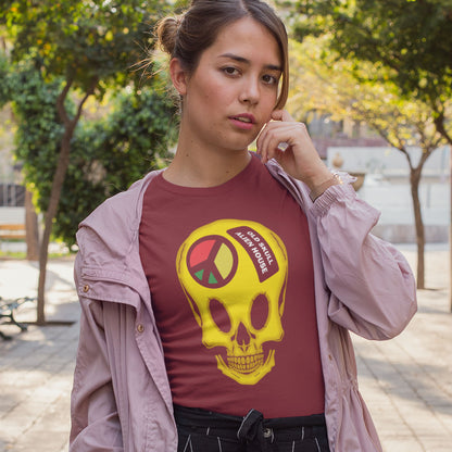 Woman wearing a burgundy t-shirt with a yellow skull design outdoors. A twisted 90's acid house t shirt design. You would be forgiven for having a fuzzy memory of the 90's if you were involved in the rave scene. An old skool acid house design for people who think outside the box and love aliens. Made from 100% organic ring-spun cotton, this funny 90's acid house t shirt is unisex, high-quality, super comfy, and best of all, eco-friendly.