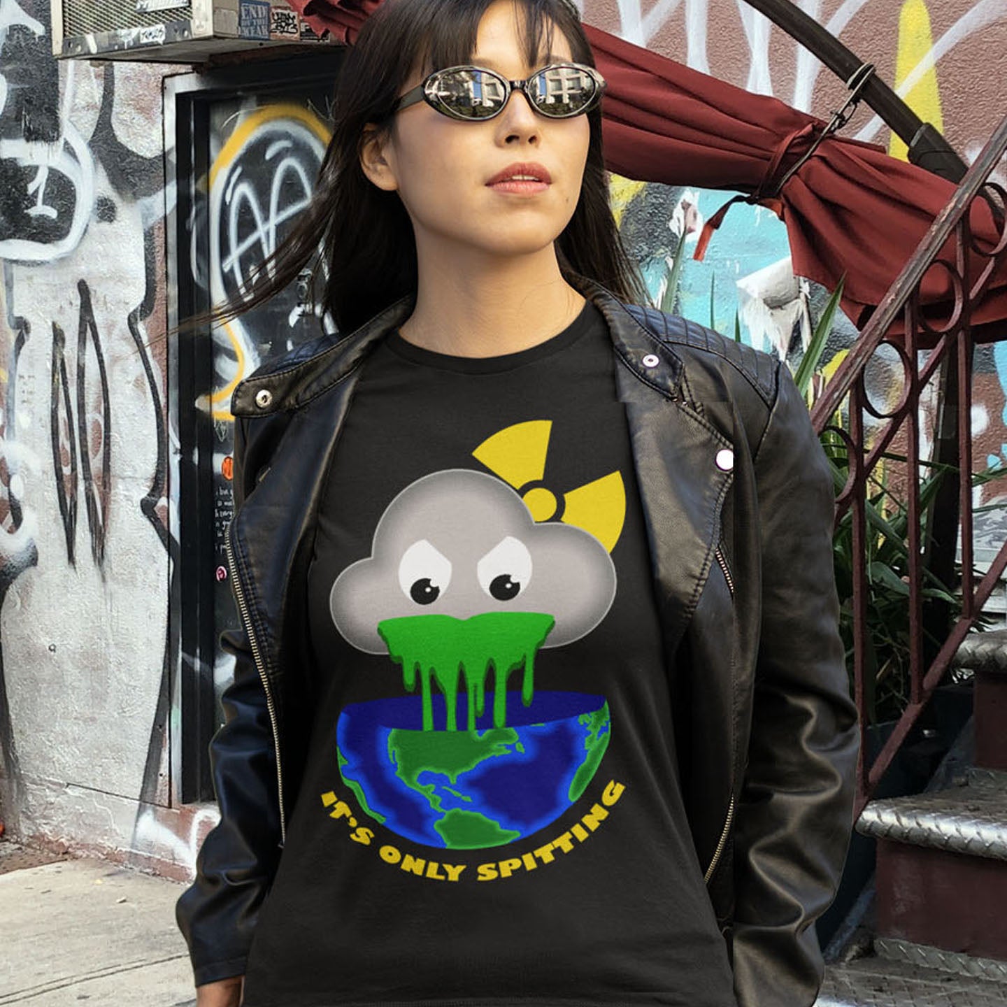 Person wearing a black t-shirt with a graphic design in front of a graffiti-covered wall. A sarcastic climate awareness t-shirt. We can pretend we're not having a climate crisis but we'll pay for it later. This unique design is a dig at actionless optimism. Made from 100% organic ring-spun cotton, this environmental awareness t-shirt is unisex, high-quality, super comfy, and best of all, eco-friendly.