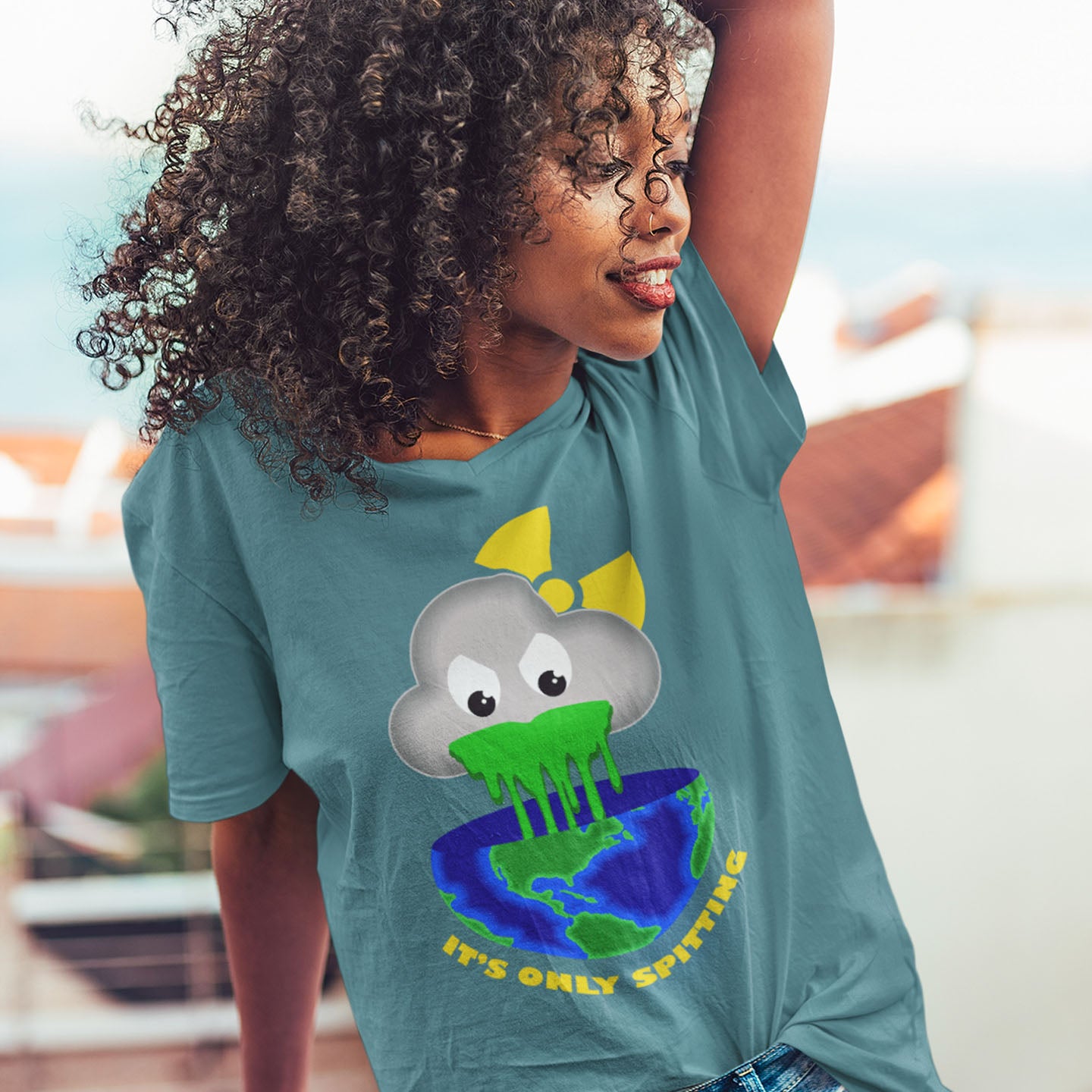 Person wearing a teal t-shirt with a cloud and earth graphic and text. A sarcastic climate awareness t-shirt. We can pretend we're not having a climate crisis but we'll pay for it later. This unique design is a dig at actionless optimism. Made from 100% organic ring-spun cotton, this environmental awareness t-shirt is unisex, high-quality, super comfy, and best of all, eco-friendly.