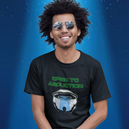 Person wearing a black t-shirt with 'Open to Abduction' graphic design on a blue background. A funny alien abduction t-shirt design for those who feel a distance forming between them and the rest of the human race, and are not too impressed with our lack of effort to save the planet. This design depicts a man open to abduction. Made from 100% organic ring-spun cotton, this witty alien abduction t-shirt is unisex, high-quality, super comfy, and best of all, eco-friendly.