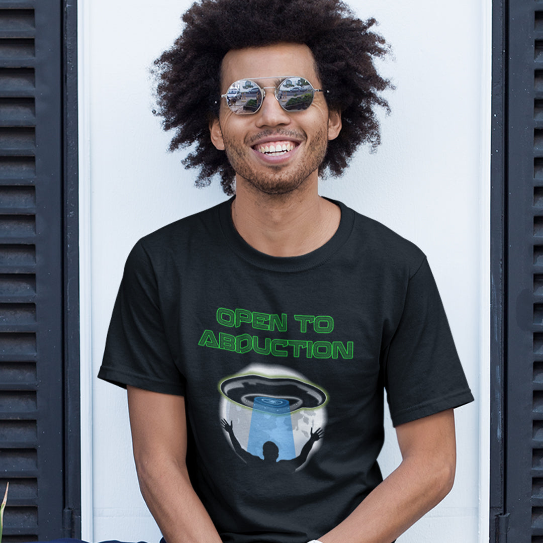Smiling man wearing a black "OPEN TO ABDUCTION" t shirt.