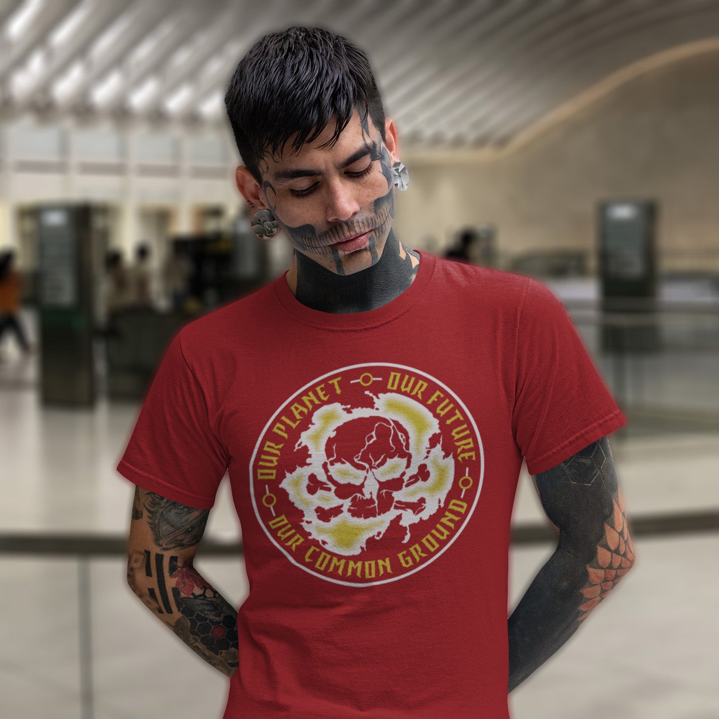 Man wearing a red t-shirt with a graphic design in an indoor setting. An environmental concern t-shirt for nature lovers who want to save the planet. Planet welfare should be something we can all agree on. Made from 100% organic ring-spun cotton, this climate concern t-shirt is unisex, high-quality, super comfy, and best of all, eco-friendly.