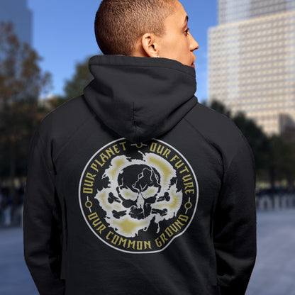 Person wearing a black hoodie with a graphic design on the back, standing outdoors. An environmental concern hoodie for nature lovers who want to save the planet. Planet welfare should be something we can all agree on. Comfortable and practical. It's extra soft and has a convenient front pouch pocket. Made from organic cotton and recycled polyester, this environmental awareness hoodie is a great eco-friendly choice.